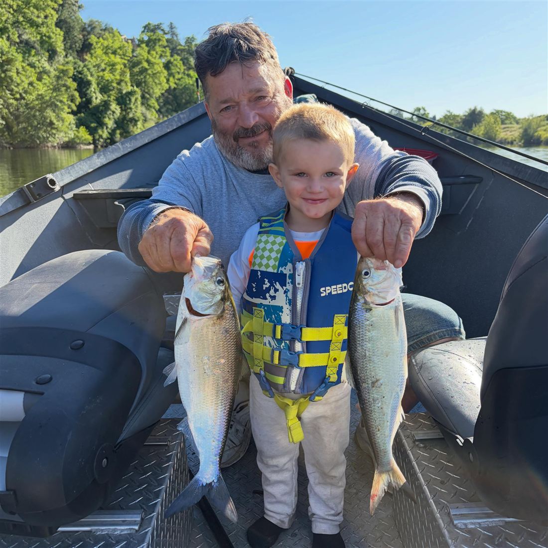 Father and young son with a pair of shad