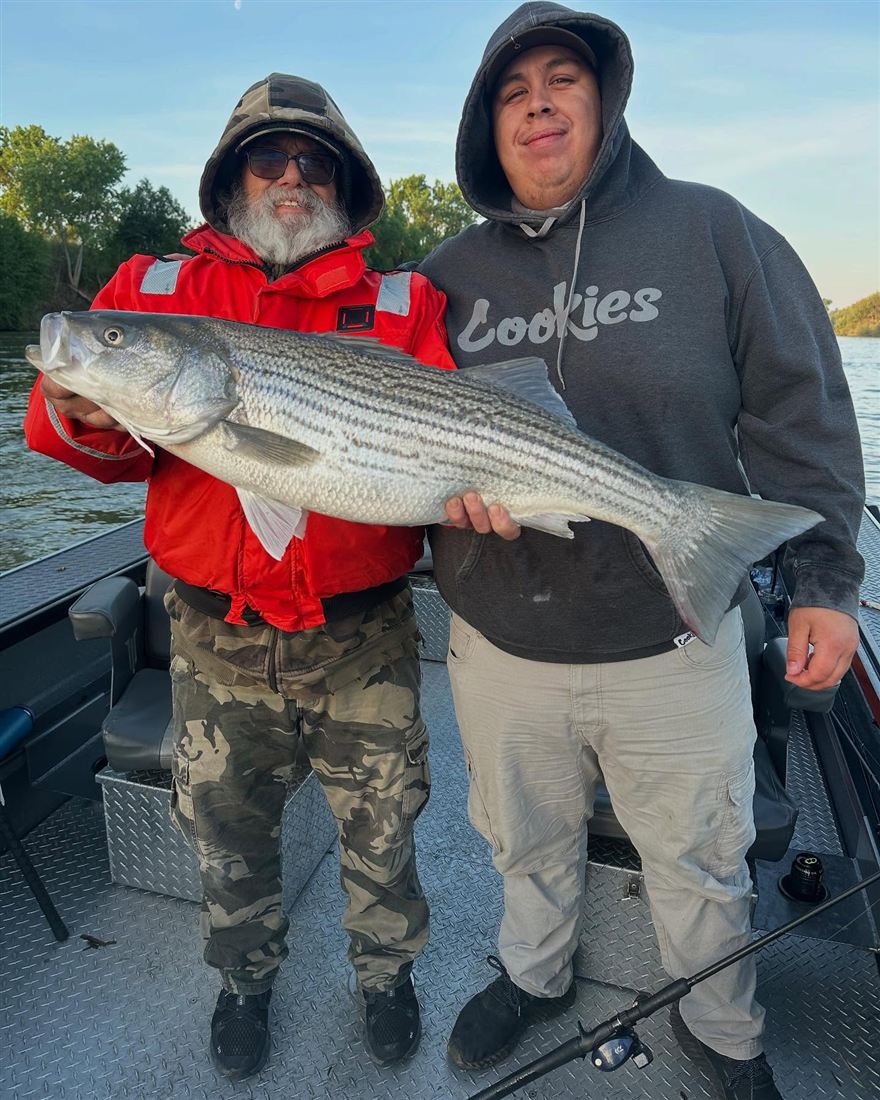 Client with a trophy striped bass